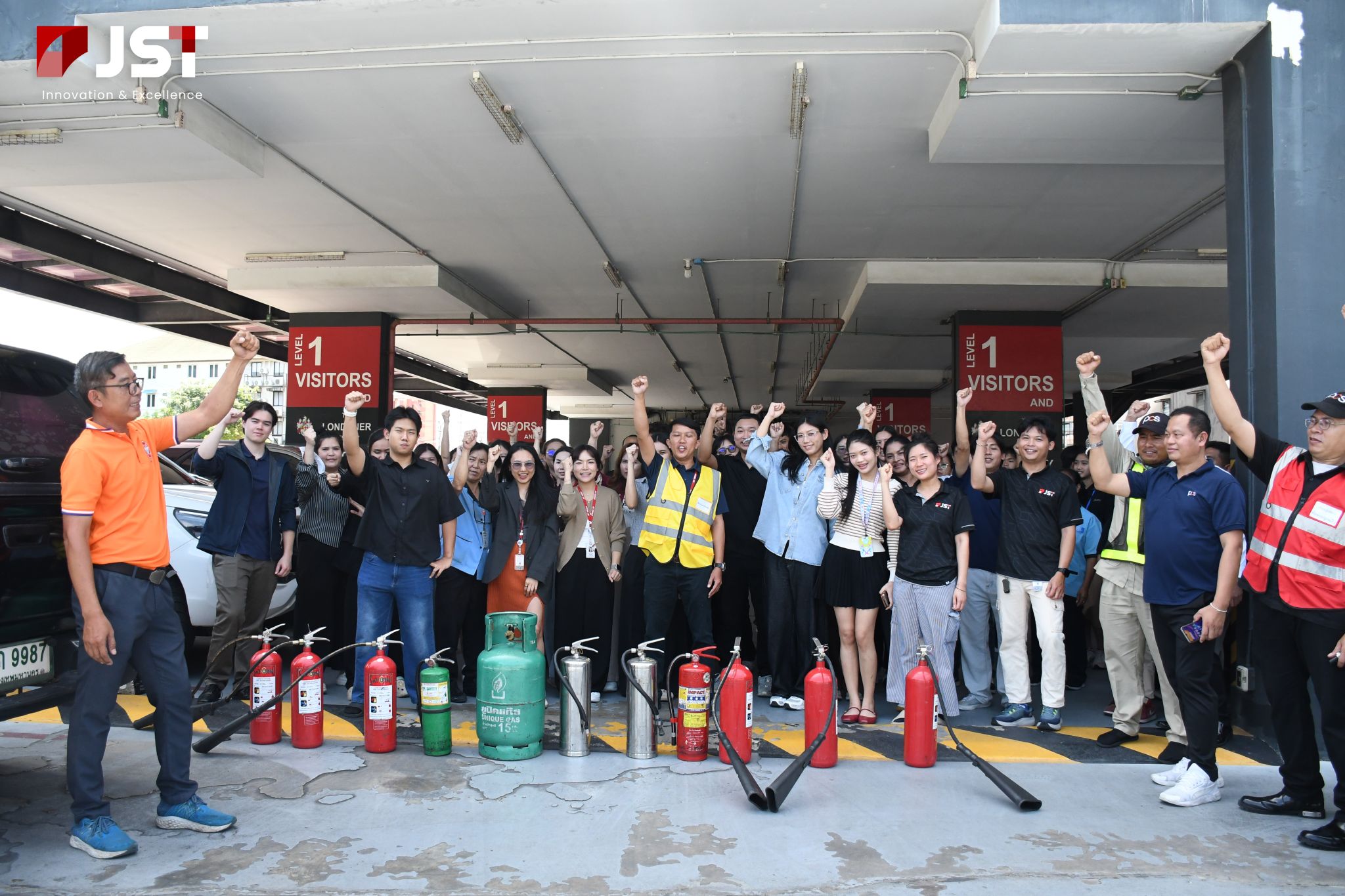 JST Group employees gathered with fire safety equipment during Fire Drill & Fire Evacuation Training 2026 at JST Tower