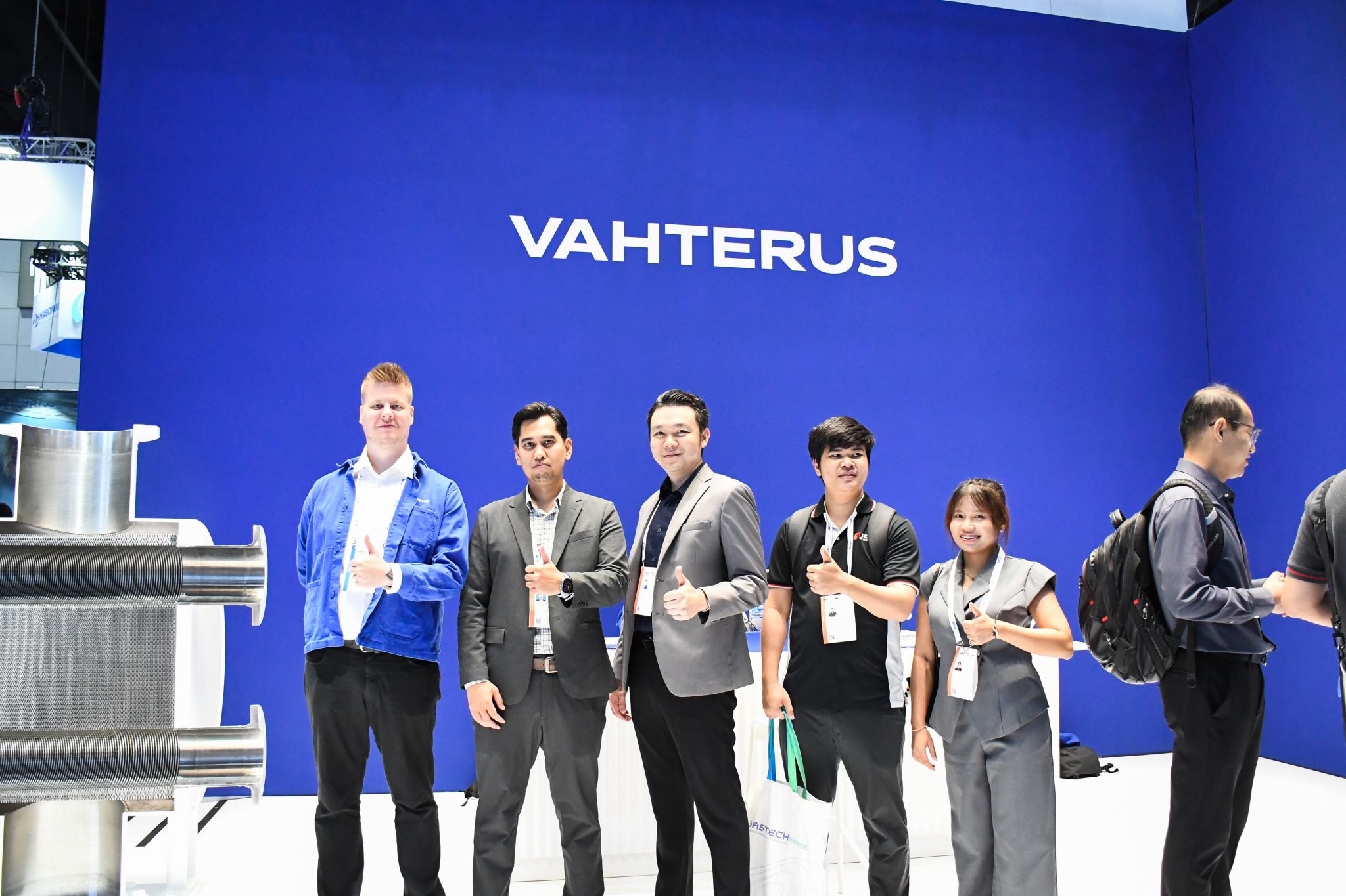 JST Group and Vahterus teams at the Vahterus stand with a Plate and Shell heat exchanger plate pack, Gastech 2026